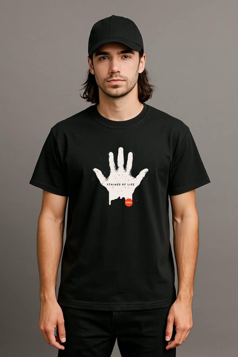 a man with long hair wearing a black shirt with a white hand on it